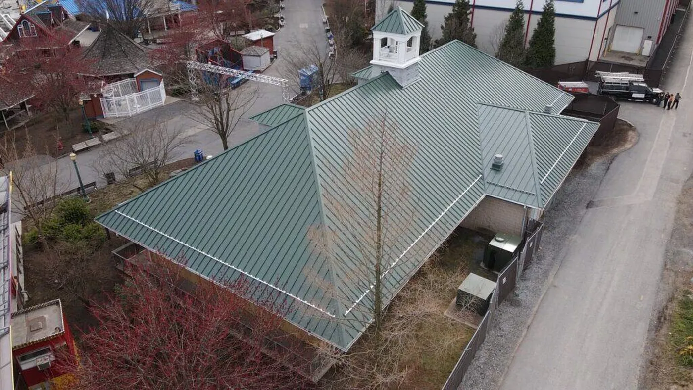 Aerial view of a large pale green metal roof in the Strack Hill Roofing project gallery