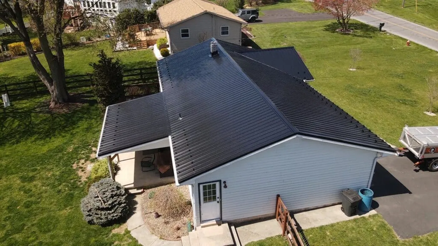 Completed dark metal roof on a single-story home
