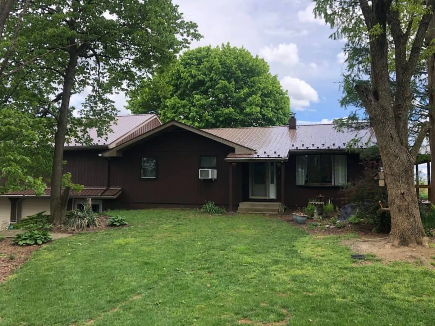 Brown metal roof project viewed from the lawn