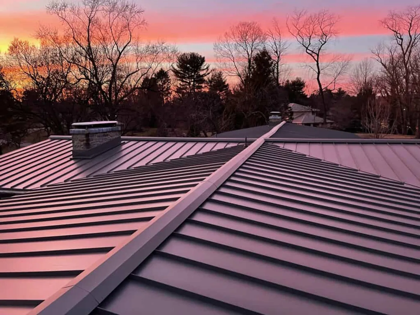 Completed standing-seam metal roof at sunset