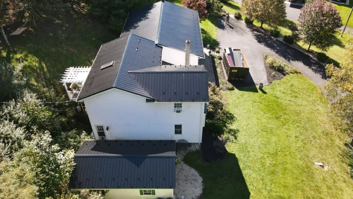Aerial view of a dark metal roof on a white home